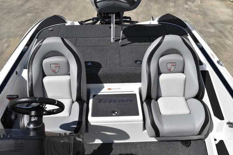 Slide: The Image of 2026 Lowe Skorpion SS boat interior with dual gray seats and steering wheel. - 24