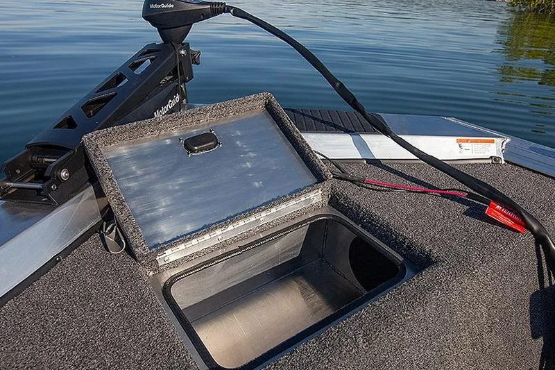 Slide: The Image of Open storage compartment on 2026 Lowe Skorpion SS boat, near water. - 6