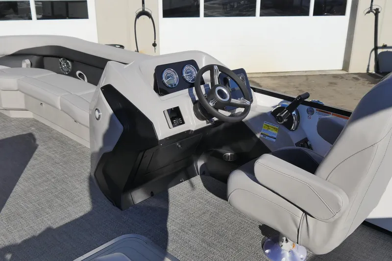 Slide: The Image of 2026 Barletta Aria 24UC boat interior with modern steering console and seating. - 4