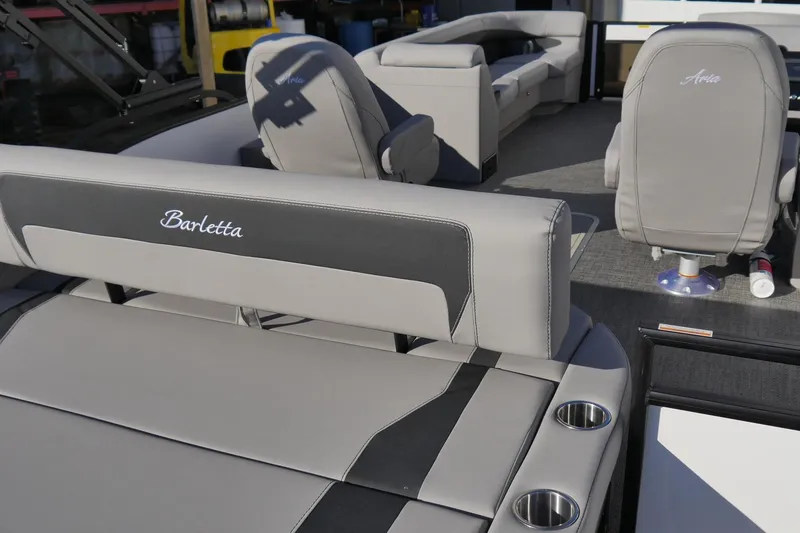 Slide: The Image of 2026 Barletta Aria 24UC boat interior with luxurious seating and cup holders. - 7