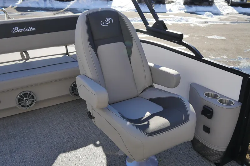 Slide: The Image of 2026 Barletta Aria 24UC boat interior with luxurious seating and cup holders. - 8