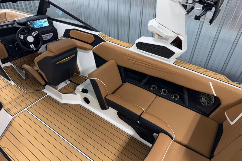 Slide: The Image of 2026 Nautique Super Air Nautique S23 interior with tan seating and modern dashboard. - 13