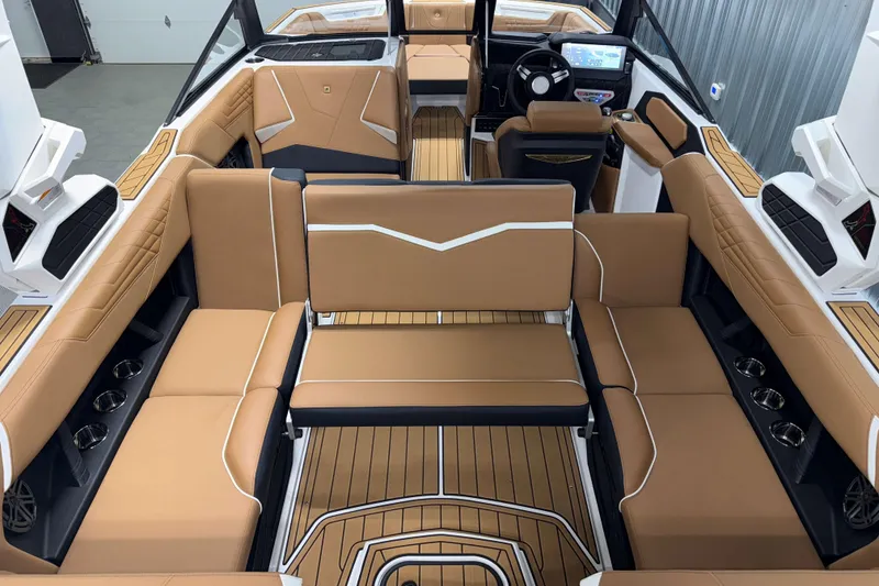 Slide: The Image of Luxurious interior of 2026 Nautique Super Air Nautique S23 with tan seating and modern dashboard. - 14
