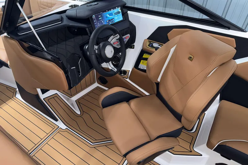 Slide: The Image of 2026 Nautique Super Air Nautique S23 interior with tan seats and modern dashboard. - 15