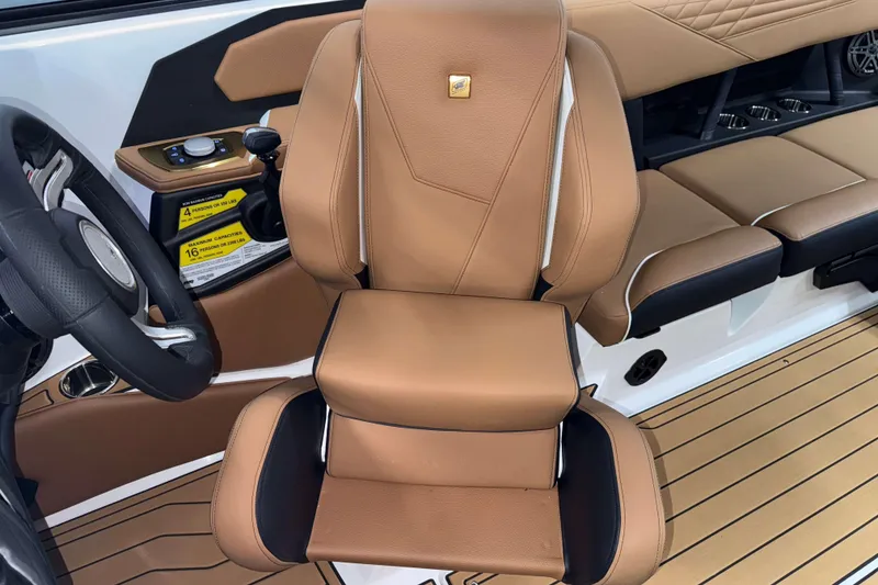 Slide: The Image of 2026 Nautique Super Air Nautique S23 interior with tan leather seating and modern controls. - 16