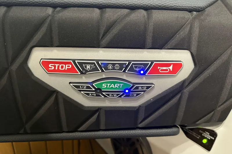 Slide: The Image of Control panel of 2026 Nautique Super Air Nautique S23 boat with start and stop buttons. - 20