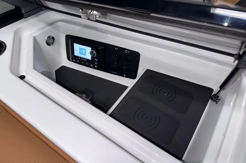 Slide: The Image of 2026 Nautique Super Air Nautique S23 dashboard with JL Audio system and wireless charging pads. - 25