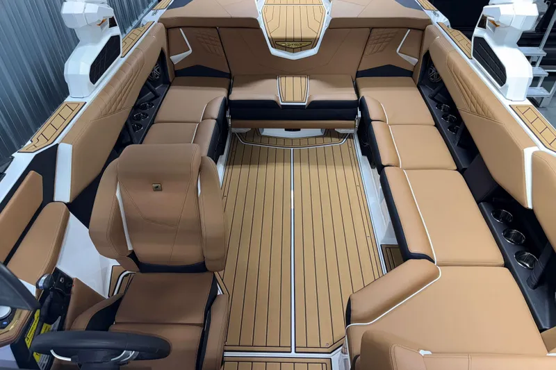 Slide: The Image of 2026 Nautique Super Air Nautique S23 interior with tan leather seating and sleek design. - 26