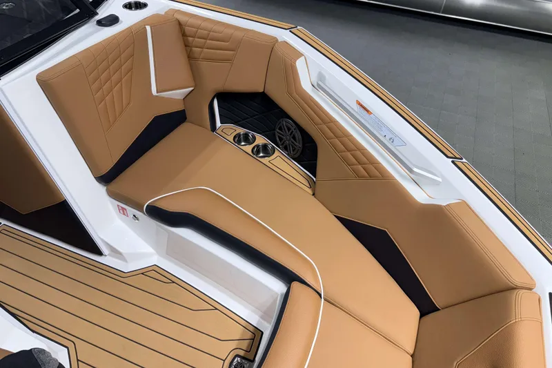 Slide: The Image of Luxurious interior of 2026 Nautique Super Air Nautique S23 boat with tan seating. - 29