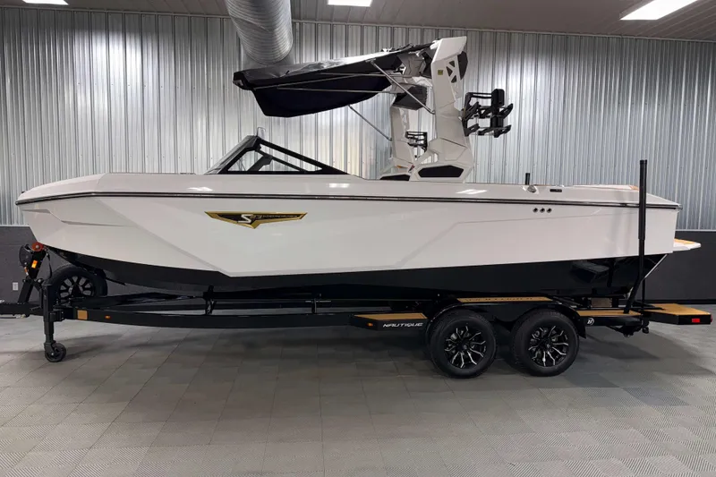 Slide: The Image of 2026 Nautique Super Air Nautique S23 boat in showroom, side view. - 38