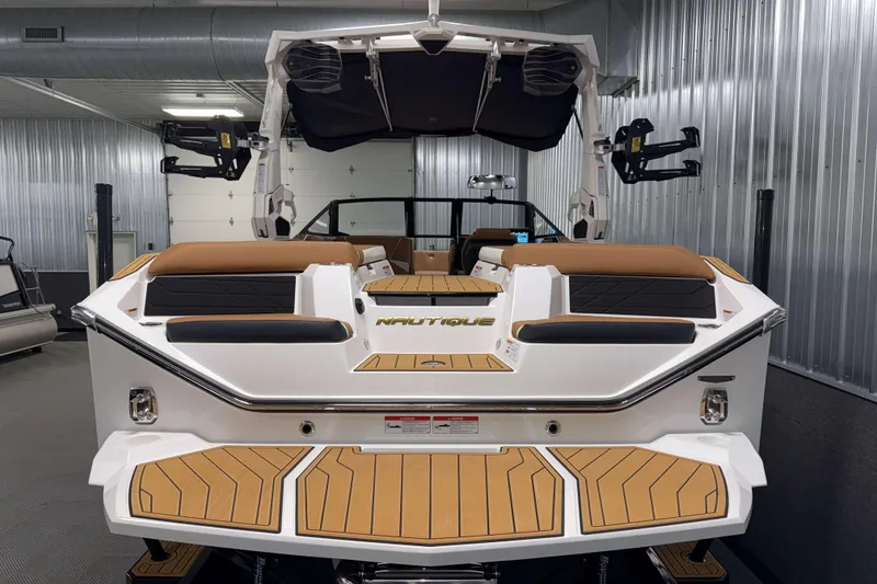 Slide: The Image of 2026 Nautique Super Air Nautique S23 boat in showroom, rear view with teak deck. - 40