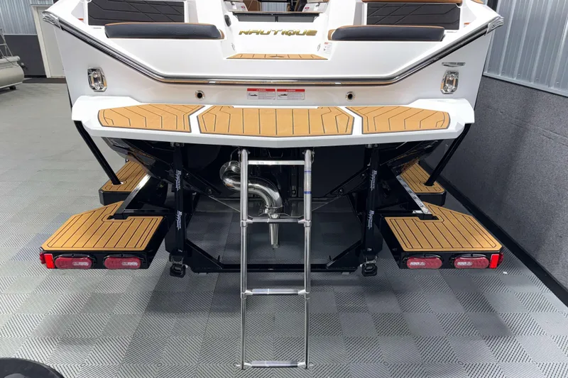 Slide: The Image of 2026 Nautique Super Air Nautique S23 boat with teak swim platform and ladder. - 41