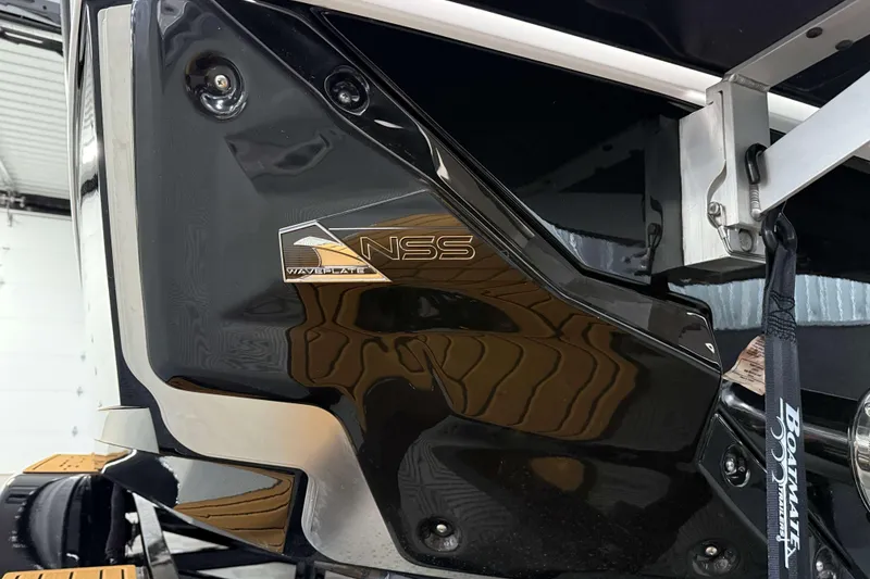 Slide: The Image of 2026 Nautique Super Air Nautique S23, NSS WAVEPLATE detail, sleek black finish. - 43