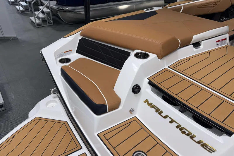 Slide: The Image of 2026 Nautique Super Air Nautique S23 boat with tan seating and deck, showcasing luxury design. - 5