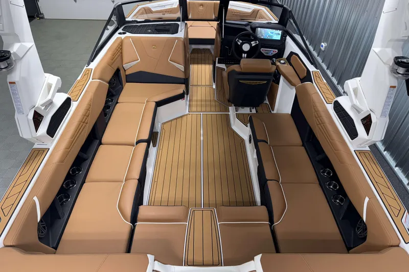 Slide: The Image of 2026 Nautique Super Air Nautique S23 interior with tan seating and modern dashboard. - 7