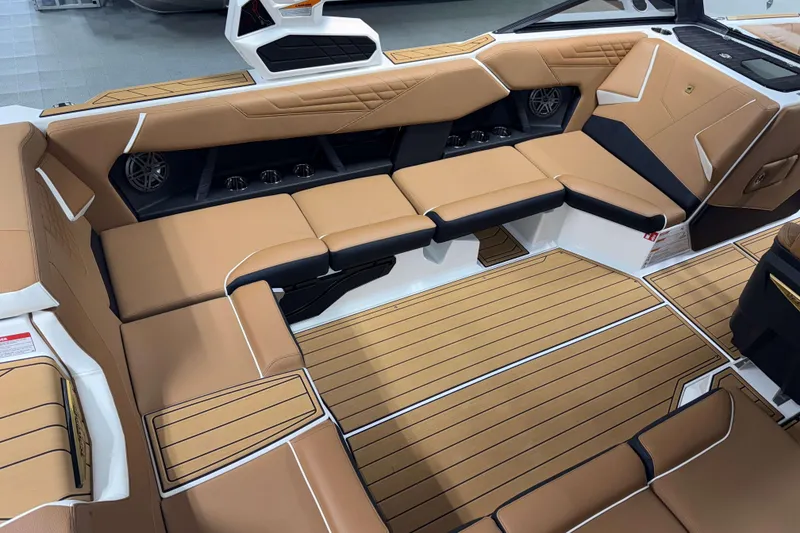 Slide: The Image of Luxurious interior of 2026 Nautique Super Air Nautique S23 boat with tan seating. - 8