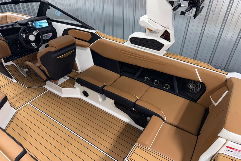 Slide: The Image of 2026 Nautique Super Air Nautique S23 interior with tan seating and modern dashboard. - 9