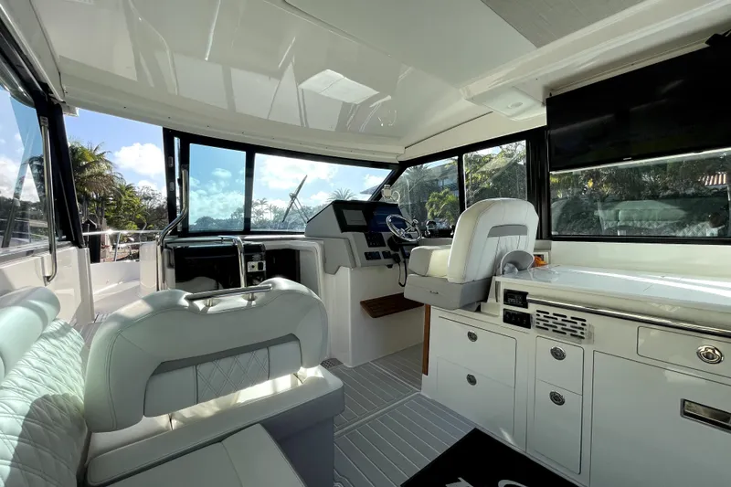 Slide: The Image of 2021 Regal 36 XO yacht interior with modern helm, seating, and cabinetry. - 36