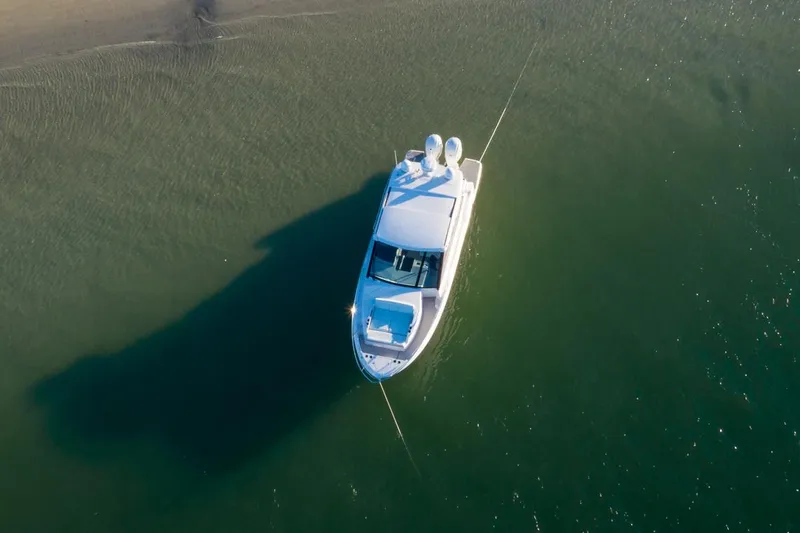 Slide: The Image of 2021 Regal 36 XO boat docked, featuring sleek design and luxurious seating. - 4