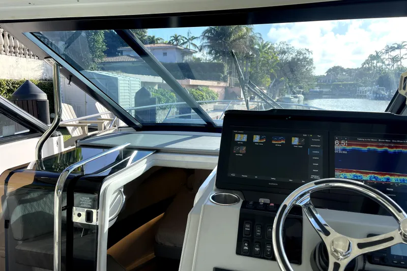 Slide: The Image of 2021 Regal 36 XO yacht cockpit with modern navigation system and waterfront view. - 42