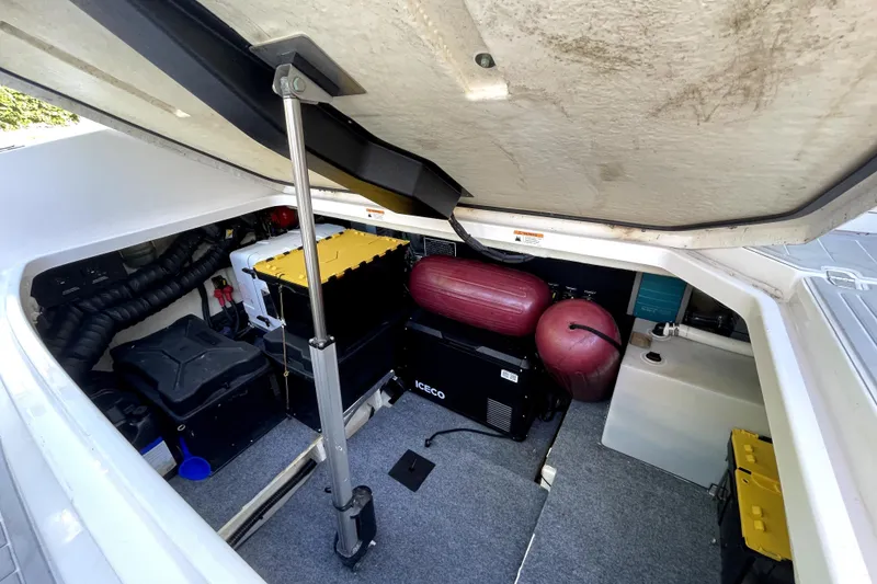 Slide: The Image of 2021 Regal 36 XO engine compartment with batteries and equipment storage. - 43