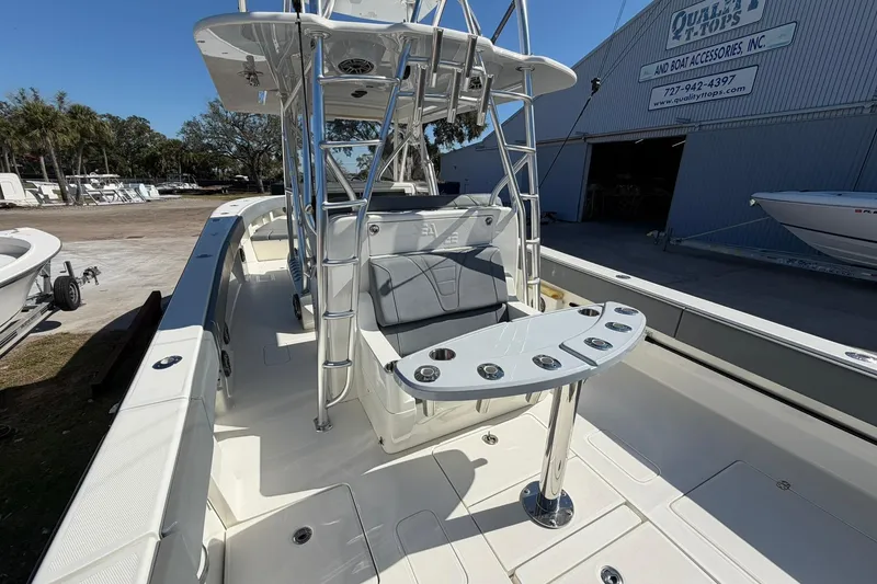 Slide: The Image of 2021 SeaVee 390Z boat with seating and rod holders, docked near a warehouse. - 10