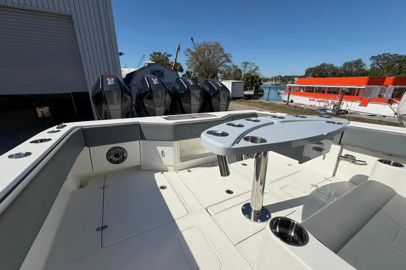 Slide: The Image of 2021 SeaVee 390Z boat interior with seating, table, and multiple outboard engines. - 12