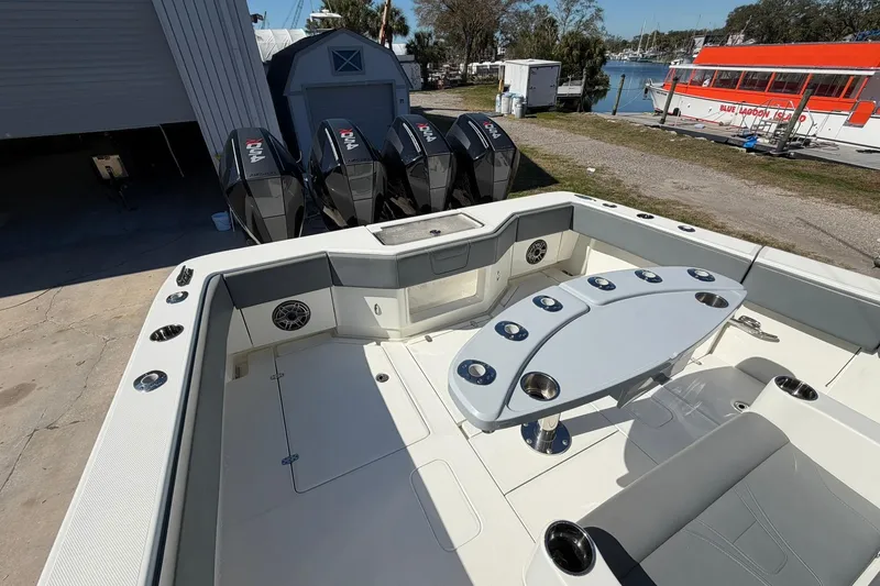 Slide: The Image of 2021 SeaVee 390Z boat deck with seating, table, and multiple outboard engines. - 13