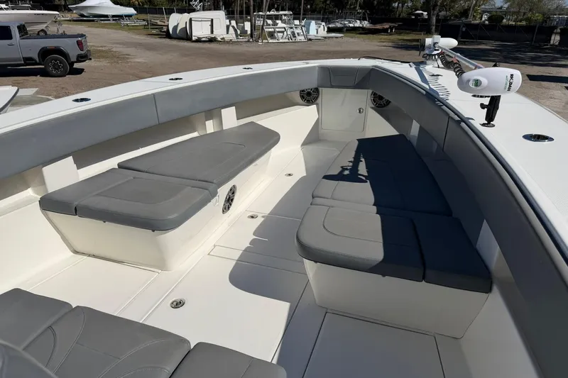 Slide: The Image of 2021 SeaVee 390Z boat interior with cushioned seating and fishing equipment. - 15