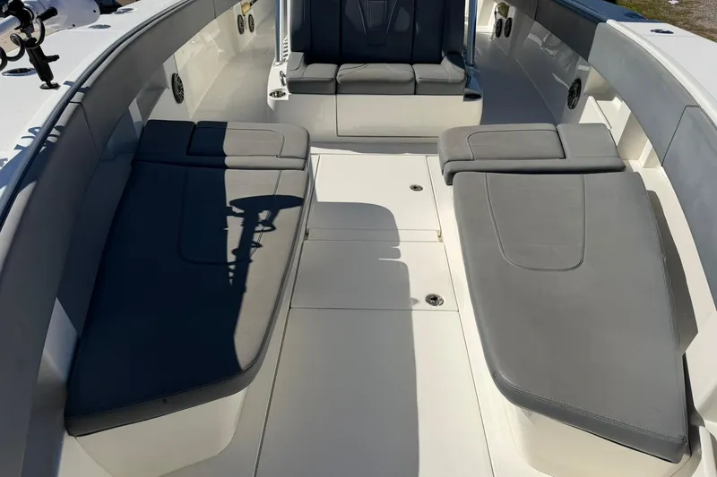 Slide: The Image of 2021 SeaVee 390Z boat interior with gray cushioned seating and spacious deck layout. - 18