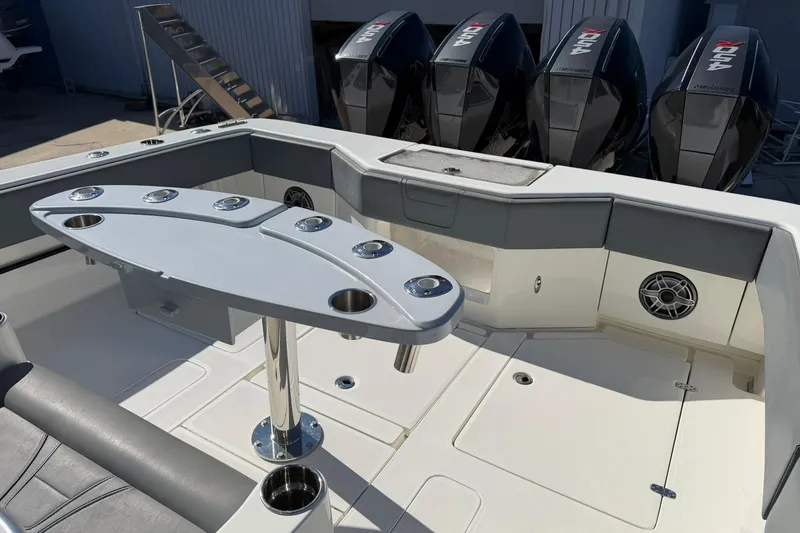 Slide: The Image of 2021 SeaVee 390Z boat interior with table and multiple outboard engines. - 22