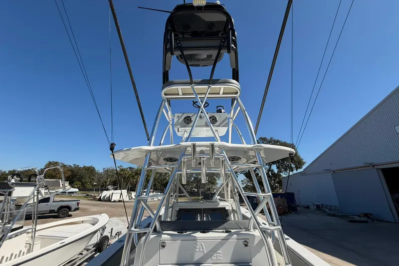 Slide: The Image of 2021 SeaVee 390Z boat with tower, docked outdoors under clear blue sky. - 24