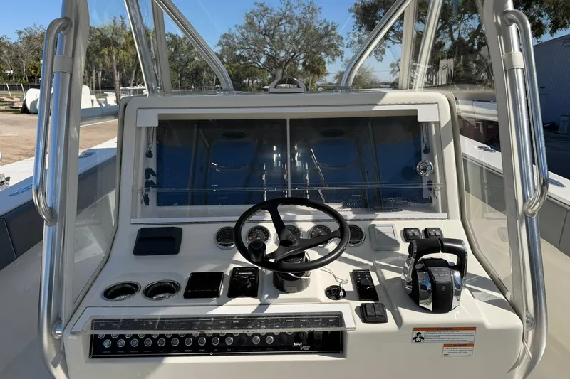 Slide: The Image of 2021 SeaVee 390Z boat dashboard with steering wheel and controls, outdoor setting. - 25