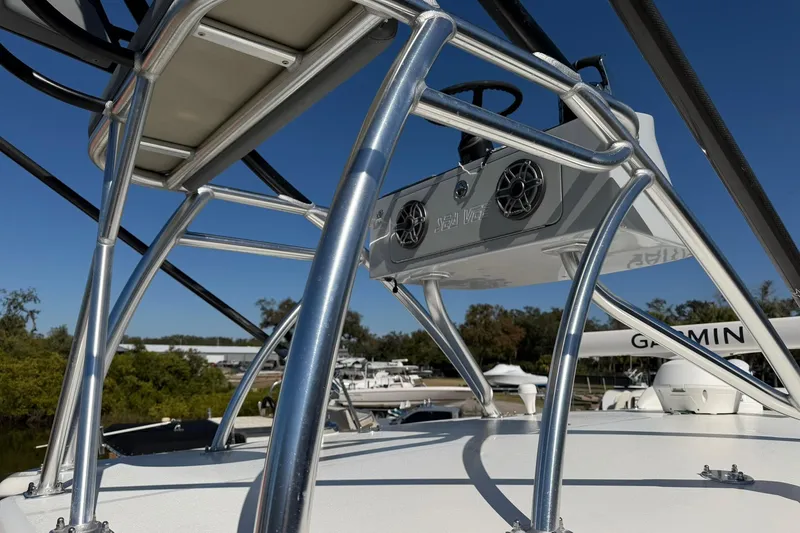 Slide: The Image of 2021 SeaVee 390Z boat with stainless steel tower and Garmin equipment, under clear blue sky. - 26