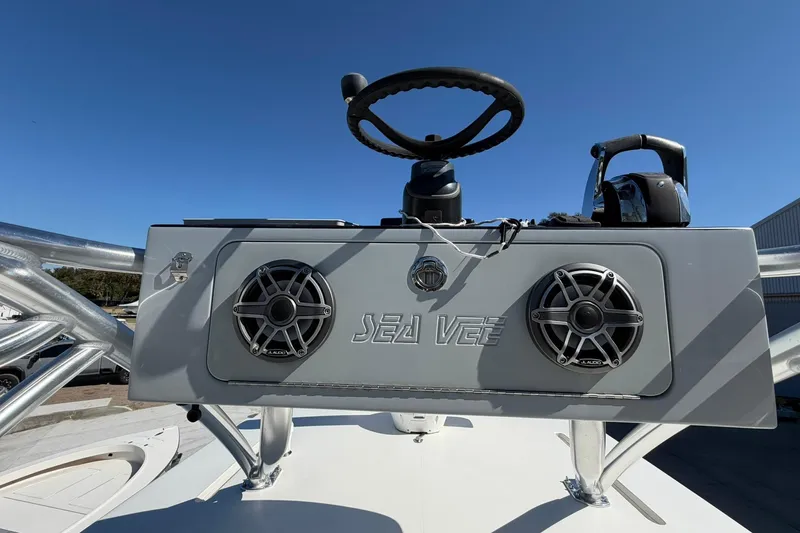 Slide: The Image of 2021 SeaVee 390Z boat console with steering wheel and speakers under clear blue sky. - 28