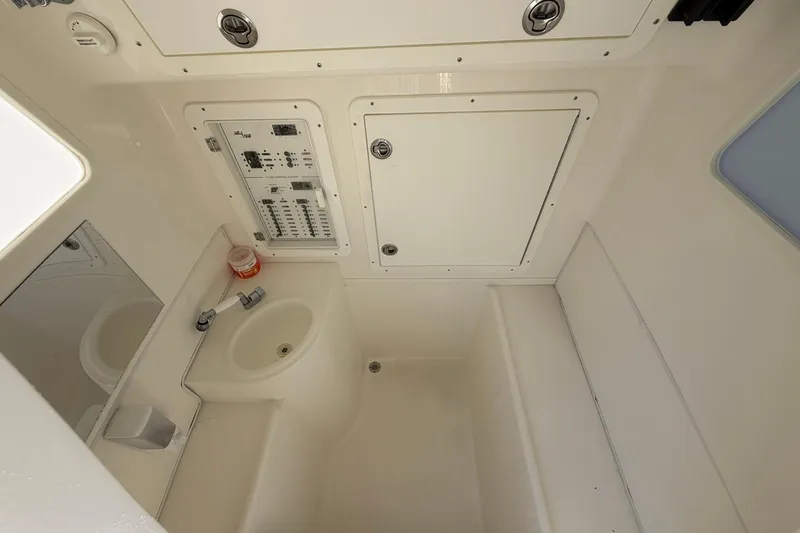 Slide: The Image of 2021 SeaVee 390Z boat interior with control panel, sink, and storage compartments. - 32