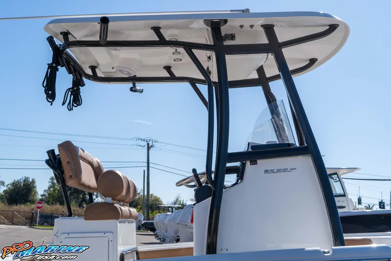 Slide: The Image of 2024 Sea Hunt BX 22 BR boat with T-top and seating, displayed outdoors. - 13