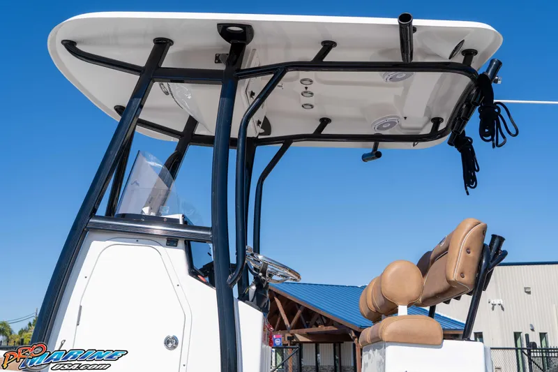 Slide: The Image of 2024 Sea Hunt BX 22 BR boat with T-top and dual seats, under clear blue sky. - 16