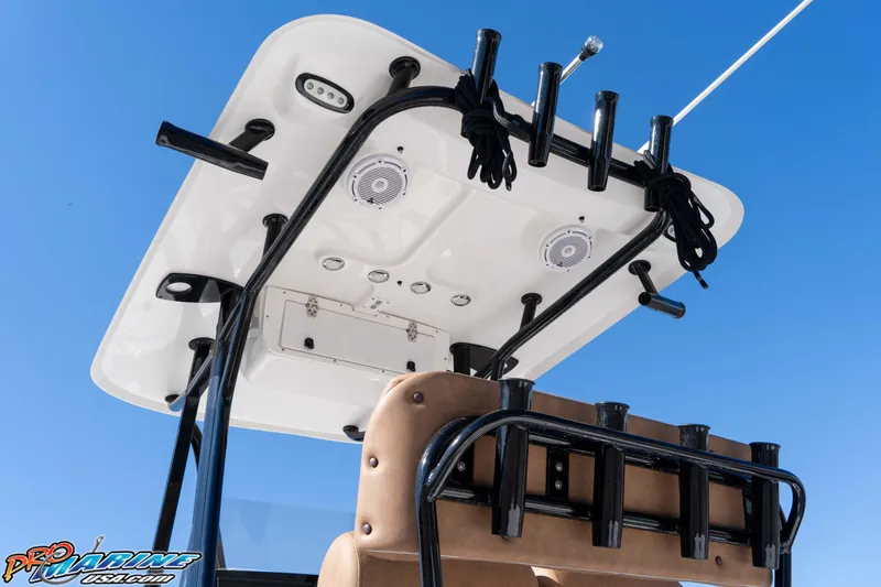 Slide: The Image of 2024 Sea Hunt BX 22 BR boat T-top with rod holders and speakers against blue sky. - 17