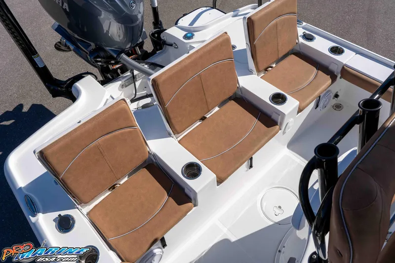 Slide: The Image of 2024 Sea Hunt BX 22 BR boat interior with brown cushioned seats and cup holders. - 19