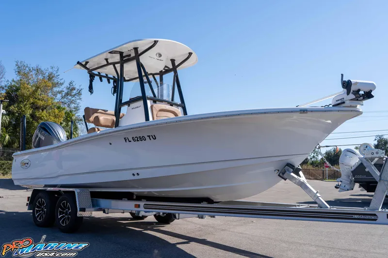 The Image of 2024 Sea Hunt BX 22 BR boat on trailer, displayed outdoors under clear sky. - 2