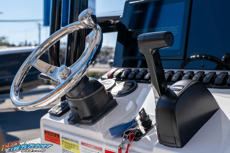 Slide: The Image of 2024 Sea Hunt BX 22 BR boat dashboard with steering wheel and controls. - 23