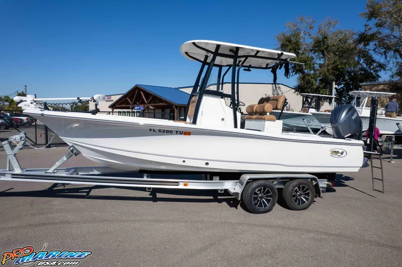 Slide: The Image of 2024 Sea Hunt BX 22 BR boat on trailer, displayed outdoors under clear blue sky. - 30
