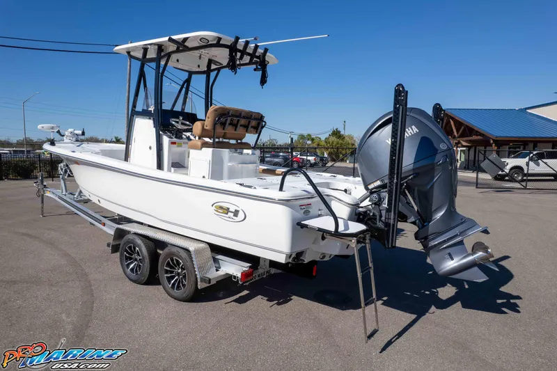 Slide: The Image of 2024 Sea Hunt BX 22 BR boat on trailer with Yamaha outboard motor, parked outdoors. - 32