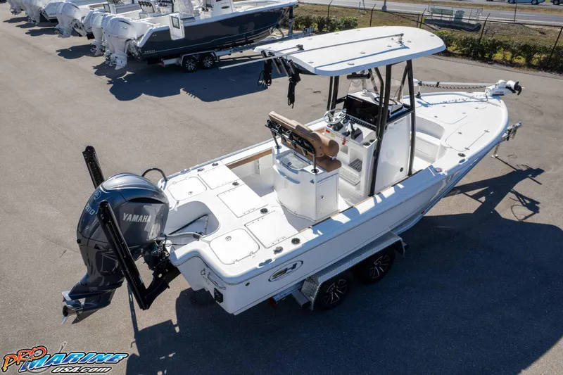 Slide: The Image of 2024 Sea Hunt BX 22 BR boat with Yamaha engine, parked on a trailer in a marina. - 38