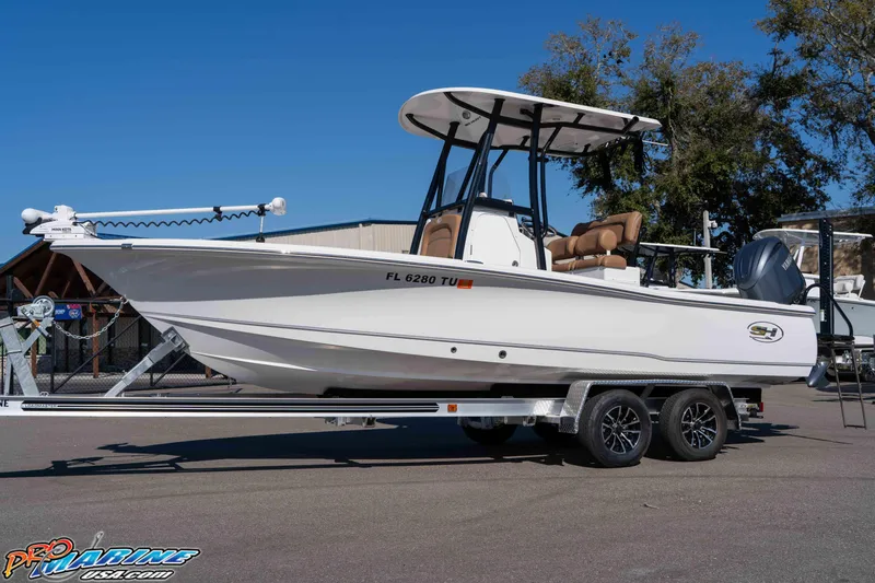 Slide: The Image of 2024 Sea Hunt BX 22 BR boat on trailer, side view, clear sky background. - 8