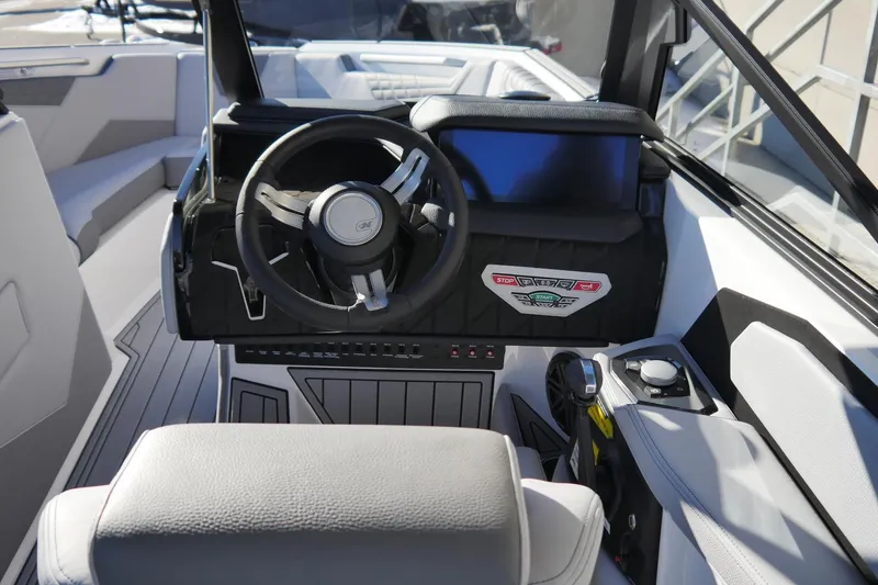 Slide: The Image of 2026 Nautique Super Air Nautique S23 boat cockpit with modern steering and controls. - 10