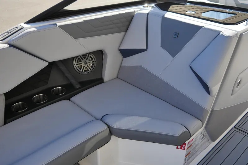 Slide: The Image of 2026 Nautique Super Air Nautique S23 interior seating with cup holders and speaker. - 7