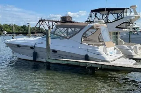 The Image of 2007 Larson Cabrio 370 boat docked at marina under clear blue sky. - 0