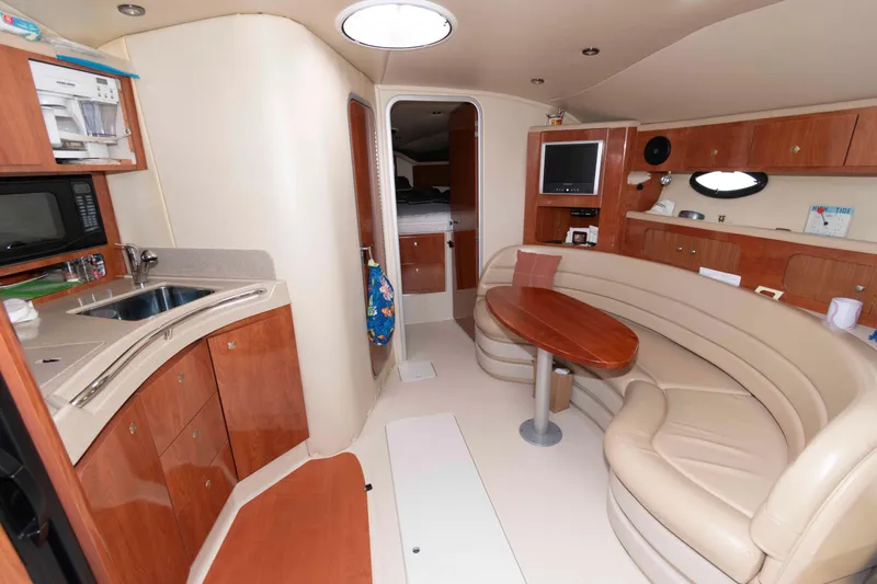 Slide: The Image of Interior of 2007 Larson Cabrio 370 yacht with kitchenette and seating area. - 10